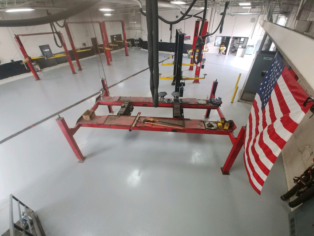 An automotive bay with a gray Industrial+ epoxy floor coating.